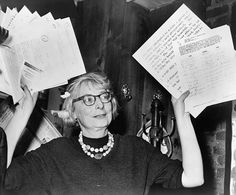 an old black and white photo of two women holding up papers in front of their faces