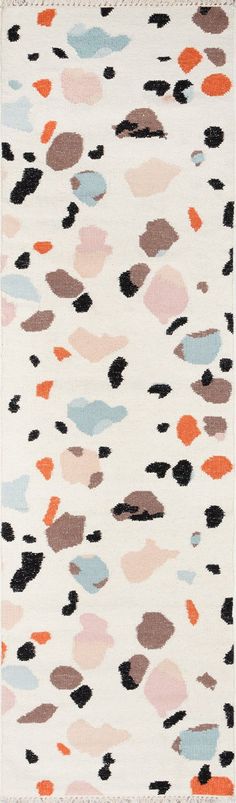 an area rug with different colored spots on it