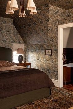 a bedroom with a bed, chandelier and bathtub in the middle of it