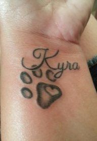 an image of a dog paw with the word kyra written in cursive writing