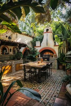 an outdoor kitchen and dining area with potted plants