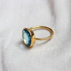 D E T A I L S - Material: Sterling silver 925 Stone: Blue Topaz Quartz (Lab Created) The fit: True to US ring size Finish: Smooth and Gold Plated to a high shine S H I P P I N G & P R O D U C T I O N - My current production time is 2-6 business days, which means after those days are up, your order ships! I make everything custom to order, by hand, but I promise you it's worth the wait! R U S H - M Y - O R D E R - If you're in a rush to get your pretty new pieces, please send me a message and Blue Emerald Sterling Silver Ring Gift, Blue Topaz Solitaire Ring Gift, Turquoise Topaz Ring With Birthstone, Turquoise Topaz Birthstone Ring, Blue Topaz Ring With Bezel Setting For Gift, Blue Topaz Ring With Bezel Setting As Gift, Blue Topaz Ring As A Gift, Turquoise Sapphire Ring Birthstone For Gift, Faceted Blue Topaz Ring