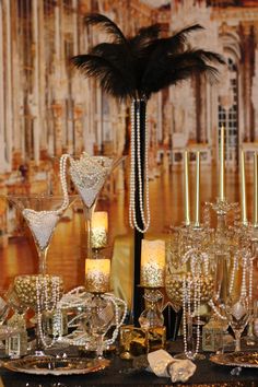 a table topped with lots of glasses and candles