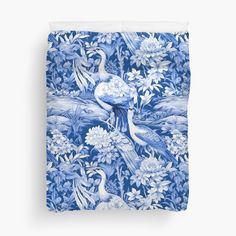 a blue and white floral print duvet cover with two birds in the middle, surrounded by flowers