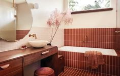 a bath room with a sink a mirror and a bath tub next to a window