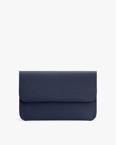 A textured clutch bag with a flap closure against a plain background. Rectangular Clutch With Removable Pouch For Work, Rectangular Workwear Clutch With Removable Pouch, Classic Clutch Pouch For On-the-go, Versatile Clutch With Removable Pouch For Work, Classic Shoulder Bag Pouch For Travel, Elegant Clutch Bag With Flat Pocket, Versatile Bag With Flat Pocket For Everyday Use, Travel Clutch Bag With Flat Pocket, Versatile Everyday Bag With Flat Pocket