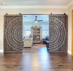 an open living room with sliding glass doors and wood flooring in front of it