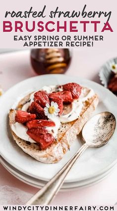 a white plate topped with bread and strawberries