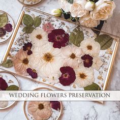 a table topped with plates covered in flowers