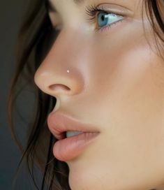 a woman with blue eyes and piercings on her nose