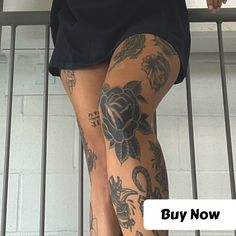 a woman with tattoos on her legs and leggings