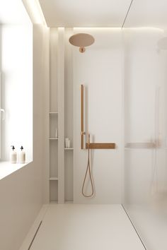 a white bathroom with a shower, sink and shelf