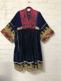 "A gorgeous, traditional Afghani Kutchi dress made by hand. Me asurements are 20\" across the chest. 48\" from mid shoulder to the bottom of the piece. 19 1/2\" long from shoulder to wrist." Intricate Embroidered Tunic Dress For Festivals, Fitted Dress With Embroidered Border In Traditional Drape, Bohemian Multicolor Embroidered Dress, Ceremonial Bohemian Dresses, Bohemian Embroidered Dress With Traditional Drape For Ceremonial Occasions, Multicolor Dress With Embroidered Border And Traditional Drape, Ceremonial Fitted Dress With Embroidered Border, Traditional Ceremony Dress With Embroidered Border, Fitted Dress With Embroidered Border And Traditional Drape