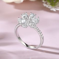 This delicate six-petal flower ring is absolutely stunning. Each petal of the flower is delicately crafted from a radiant pear-shaped stone, shimmering with a captivating brilliance that catches the eye and captivates the heart.It is the perfect accessory for any special occasion or everyday wear. And is sure to be cherished by loved ones.Carat Weight: 3.989 ctStone Size: 4*6,1.2,1.4,2.5 mmStone Type: Jeulia® StoneNumber of Stones: 21 Stone Color: Diamond WhiteStone Shape: Pear, RoundWeight: 3.1 Petal Flower, White Stone, Flower Ring, Pear Cut, Pear Shaped, Diamond White, Sterling Silver Ring, Fashion Rings, Stone Color