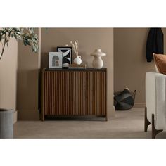 a living room scene with focus on the sideboard and chair in the foreground