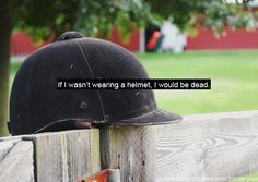 a helmet on top of a wooden fence with the words if i want wearing a helmet, i would be dead