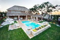 an outdoor swimming pool surrounded by lush green grass