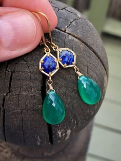 Lapis Lazuli and Green Onyx Earrings, Blue and Emerald Green Dangle Earrings, May Birthstone Drops in Gold, Gemstone Statement Jewelry Gift These rich and vibrant color earrings feature Lapis Lazuli free form gemstones bezeled in gold filled and suspended from them are flawless quality micro faceted green onyx teardrops wire wrapped in gold filled. The earrings come suspended from gold filled lever back ear wires. These earrings are colorful and are sure to make a statement, the navy and dark gr Green Dangle Earrings, Bridal Party Jewelry, Color Earrings, Onyx Earrings, May Birthstone, Emerald Earrings, Blue Jewelry, Amethyst Earrings, Earrings Blue