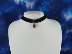 This is a Alice in Wonderland inspired black velvet choker that features a mini diamond card suit charm. It is made with 3/8 inch black velvet, and a small enameled metal diamond charm. The necklace is 14 inches long and features a 2 inch extender chain. DETAILS: *      3/8 inch black velvet ribbon  *Uses stainless steel metal = safer for sensitive skin / won't fade or turn green  *Red enamel and antique gold metal red diamond charm SIZING:  *14 inches in length *       2 inch extension chain so Diamond Card, Black Velvet Ribbon, Alice In Wonderland Inspired, Choker Black, Black Velvet Choker, Velvet Choker, Red Diamond, Black Choker, Necklace Minimalist