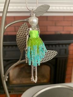 a necklace is hanging from a stand near a fireplace