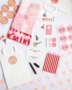 various stationery items laid out on top of a table with paper and stickers