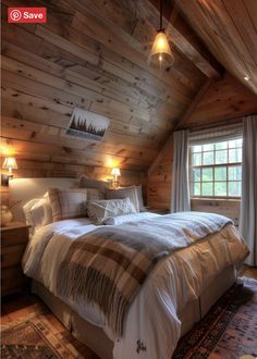 a large bed sitting in the middle of a bedroom next to two lamps on either side of a window