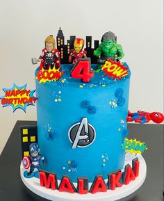 a birthday cake decorated with avengers and captain america figures