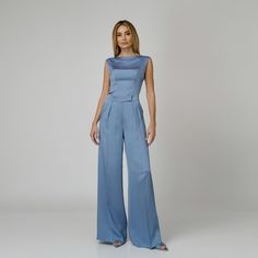 A harmonious blend between comfort and sophistication, our Skye Silk Wide-Leg Pants redefine elegance with every step. Impeccably tailored from blue double silk satin, they present a flattering high-waist with expertly placed darts and a wide-leg cut with a pressed crease detail which visually elongates the silhouette. The concealed zipper and hook fastening in the front ensures ease of wear and a seamless finish.  Match: Complete the look with the Skye Silk Camisole.  Each Il Volo item is handmade by skilfull artisans in our Bucharest atelier and it is created in limited series. 100% Italian Double Silk Satin.  Gentle dry clean. Do not wash. Do not use chlorine based bleach. Do not tumble dry. Cool iron, max 110 C.  Made in EU. Luxury Satin Pants For Workwear, Luxury Satin Pants For Work, Elegant Wide Leg Satin Pants For Formal Occasions, Elegant Satin Wide Leg Pants For Formal Occasions, Blue Satin Bottoms For Formal Occasions, Elegant Satin Pantsuit For Evening, Elegant Formal Bottoms With Satin Finish, Formal Blue Satin Bottoms, Elegant Silk Bottoms With Satin Finish