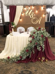 the table is decorated with greenery and candles for an elegant touch to the reception