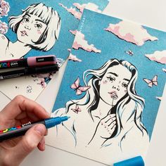 a person is drawing on some paper with marker pens and crayon pencils