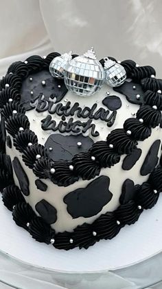 a birthday cake decorated with black and white frosting