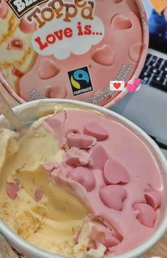 a bowl of ice cream with some kind of topping in it next to a laptop