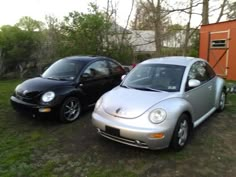 two cars parked next to each other in the grass