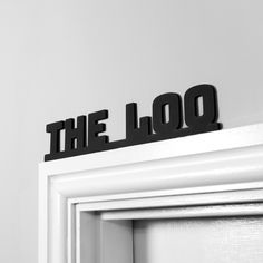 the word the loq is placed on top of a door handle in front of a white wall