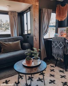 a living room filled with furniture next to a window and a rug on the floor