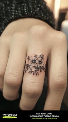 a woman's hand with a flower tattoo on it