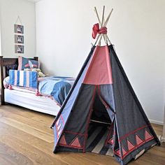 a teepee tent sitting on top of a wooden floor