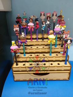 the wooden stand has many different colored items on it and is made out of wood