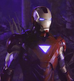 iron man standing in the woods with his hands on his hips and glowing blue eyes