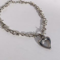 "Introducing our stunning Silver Wire Necklace Statement Necklace, featuring a stainless steel puffy heart pendant. This exquisite piece is rhodium plated brass with tarnish-resistant coating, ensuring its long-lasting shine. The necklace measures 19 inches in length, with an additional 2-inch extension, making it versatile and suitable for both men and women.  To customize your necklace, please choose your desired finish and length from the convenient drop-down menu provided. We take pride in o Y2k Heart-shaped Valentine's Day Jewelry, Valentine's Day Heart-shaped Y2k Jewelry, Valentine's Day Heart Shaped Y2k Jewelry, Valentine's Day Y2k Heart Jewelry, Chunky Metal Necklace With Heart Pendant, Chunky Metal Heart Pendant Necklace, Edgy Silver Heart-shaped Necklace, Heart Charm Y2k Jewelry For Gifts, Y2k Style Heart Charm Jewelry Gift