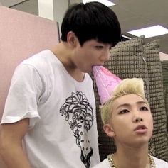 two young men standing next to each other in front of a hairdryer and blow dryer