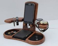 a cell phone is sitting on top of a wooden stand with other items around it