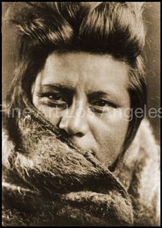 an old black and white photo of a woman wearing a fur coat with her mouth open