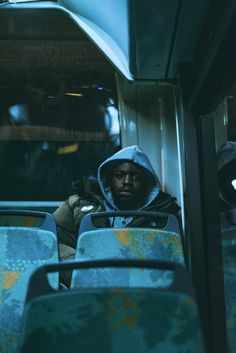 a man sitting on a bus in the dark