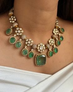 The Emerald Green Uncut Diamond Kundan Necklace Set is a stunning piece of jewelry that draws inspiration from the grandeur of Sabyasachi's designs and the opulence of Bollywood fashion. This statement necklace set is meticulously handcrafted, featuring uncut diamonds set in traditional Kundan style, which is known for its intricate detailing and elaborate craftsmanship. The rich emerald green stones add a vibrant touch, symbolizing luxury and elegance. Each uncut diamond is carefully placed to Necklace For Green Saree, Luxury Green Stone Work Sets, Luxury Green Kundan Necklace For Wedding, Emerald Jewelry Necklace, Green Emerald Necklace, Emerald Green Stone, Kundan Necklace Set, Traditional Indian Jewellery, Kundan Necklace