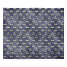 a blue and gold patterned area rug with an abstract design on the bottom, in front of a white background