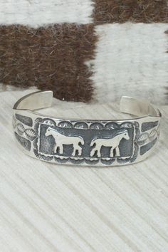 This sterling silver bracelet was made by Navajo silversmith Emerson Kinsel. The inside is signed K and stamped sterling.Size: 5 1/2" (will fit up to a 6 3/4" wrist)Gap: 1 1/4"Length: 7/8"Free shipping on all orders! We ship with USPS and always include tracking. All orders ship within a day of payment.Returns are accepted up to 30 days after you receive your order. Just send us a message. Our shop offers cash back or store credit. The item must be returned in new condition. Nickel-free Southwestern Sterling Silver Bracelet, Sterling Silver Etched Bangle Bracelet, Etched Sterling Silver Bangle, Artisan Silver Bracelet With Stamped Details, Etched Sterling Silver Bangle Bracelet, Adjustable Sterling Silver Bracelet In Antique Silver, Adjustable Southwestern Sterling Silver Bracelet, Stamped Sterling Silver Bangle Bracelet, Stamped Sterling Silver Bangle