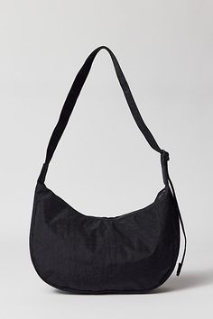 BAGGU medium nylon crescent bag. BAGGU’s crescent bag in a medium size that’s effortlessly casual and large enough to carry more than just the essentials. Comfy everyday BAGGU shoulder bag silhouette with an adjustable tonal logo strap, it wears comfortably across the body or on the shoulder for a hands-free experience. The BAGGU medium crescent bag comes complete with two interior pockets that make it easy to stay organized. Made of recycled heavyweight nylon with a recycled ripstop lining. Fea Medium Size, Crescent, Urban Outfitters, Shoulder Bag, ? Logo, How To Wear, Black