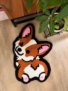 a rug that looks like a corgi is sitting on the floor next to a potted plant