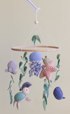 a crocheted mobile with sea animals hanging from it's sides and leaves